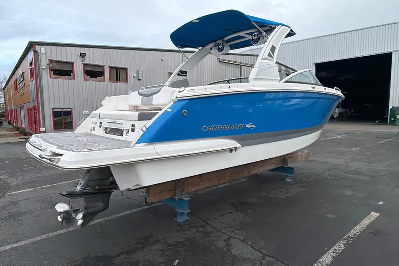 Slide: The Image of 2018 Chaparral 267 SSX boat in blue and white, displayed outdoors. - 6
