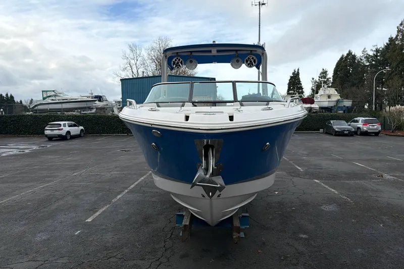 Slide: The Image of 2018 Chaparral 267 SSX boat in a parking lot, front view, overcast sky. - 7