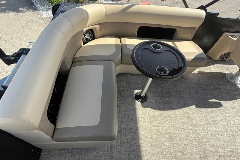 Slide: The Image of 2024 Premier Sunspree boat interior with beige seating and round table. - 11