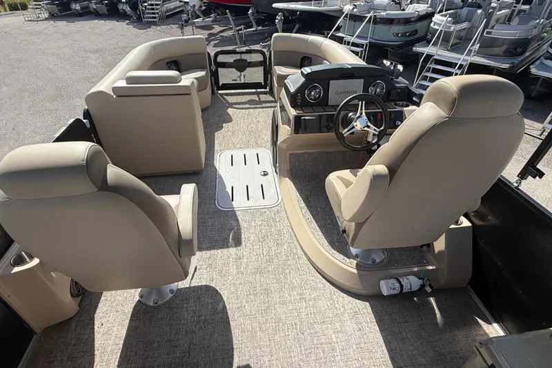 Slide: The Image of 2024 Premier Sunspree boat interior with beige seating and Garmin dashboard. - 13