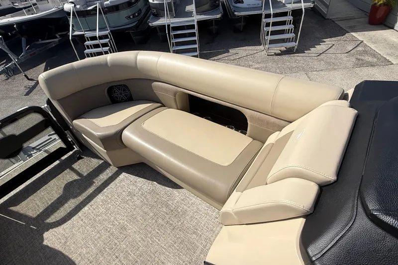 Slide: The Image of 2024 Premier Sunspree boat interior with beige seating and speaker detail. - 15
