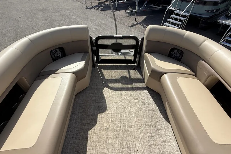 Slide: The Image of 2024 Premier Sunspree boat interior with beige seating and carpeted floor. - 17