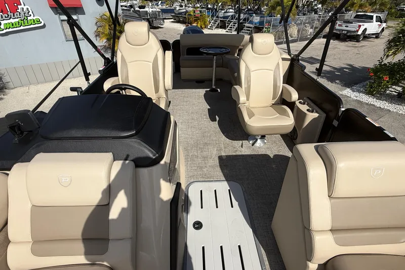 Slide: The Image of 2024 Premier Sunspree boat interior with beige seating and modern design. - 18