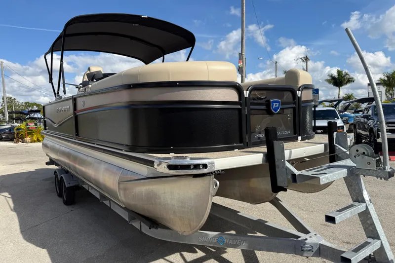 Slide: The Image of 2024 Premier Sunspree pontoon boat on trailer under clear blue sky. - 4
