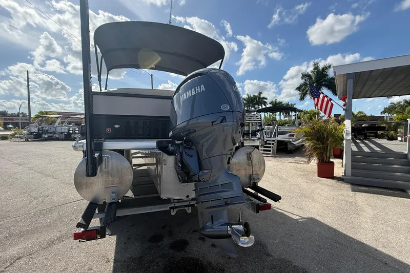 Slide: The Image of 2024 Premier Sunspree pontoon boat with Yamaha outboard motor, parked under a sunny sky. - 8