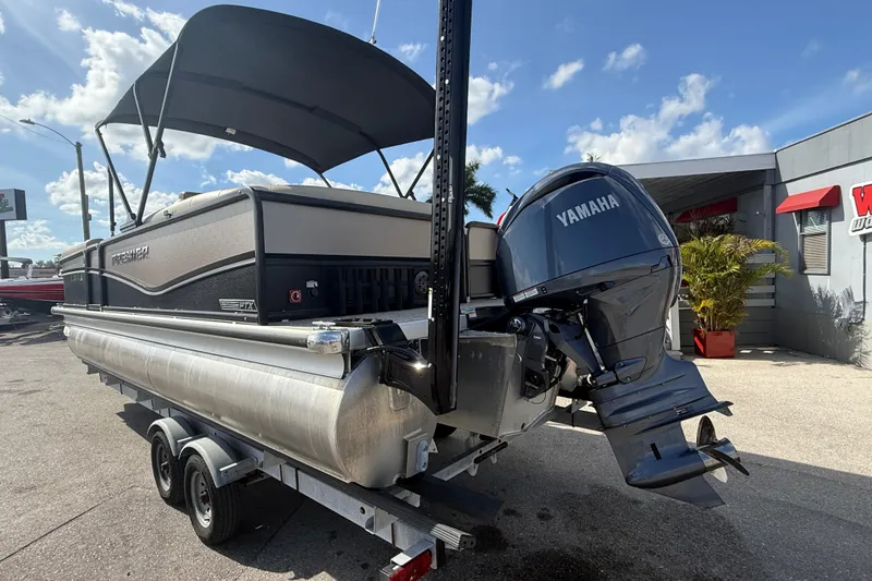 Slide: The Image of 2024 Premier Sunspree pontoon boat with Yamaha outboard motor on trailer. - 9