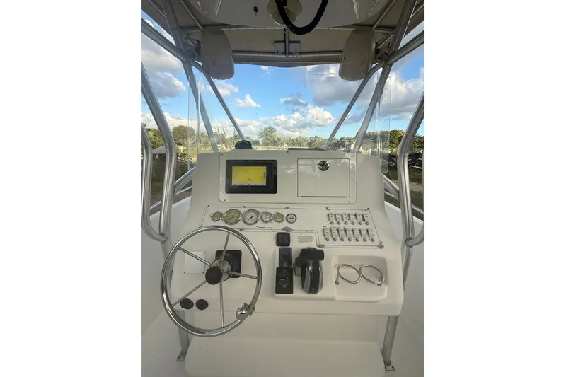 Slide: The Image of 2005 Pro-Line 24 Sport boat interior with seating and steering console. - 12