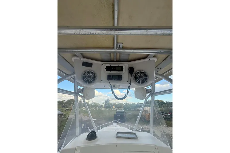 Slide: The Image of 2005 Pro-Line 24 Sport boat interior with seating and steering console. - 13