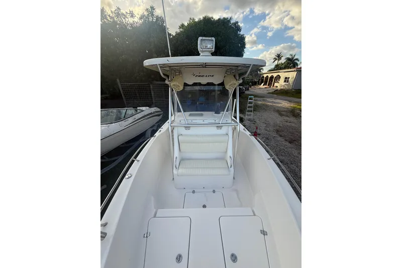 Slide: The Image of 2005 Pro-Line 24 Sport boat interior with white seating and Garmin navigation system. - 15