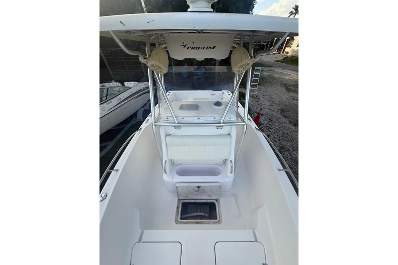 Slide: The Image of 2005 Pro-Line 24 Sport boat interior with steering console and seating. - 16