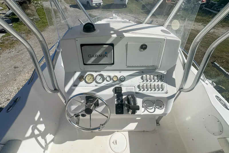 Slide: The Image of 2005 Pro-Line 24 Sport boat dashboard with Garmin navigation system and control panel. - 23