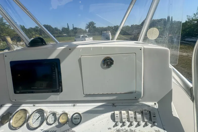 Slide: The Image of 2005 Pro-Line 24 Sport boat dashboard with gauges and navigation equipment. - 27