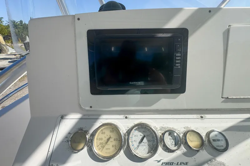 Slide: The Image of Dashboard of a 2005 Pro-Line 24 Sport boat with Garmin display and gauges. - 29