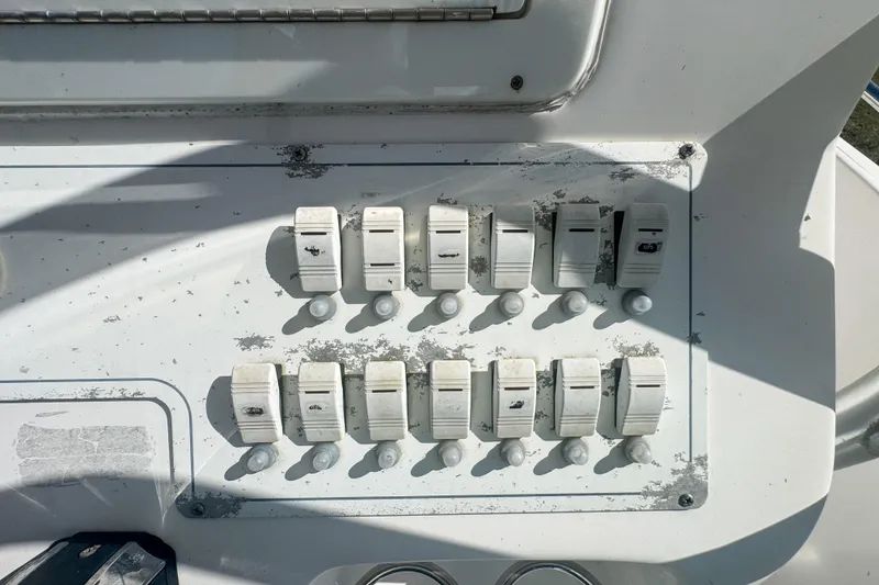Slide: The Image of Control panel of a 2005 Pro-Line 24 Sport boat with multiple switches. - 30