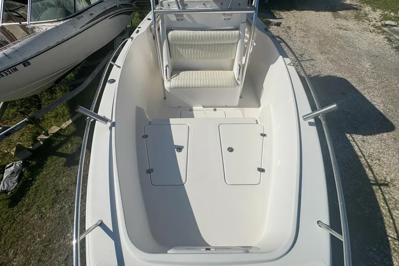 Slide: The Image of 2005 Pro-Line 24 Sport boat interior with seating and storage compartments. - 40