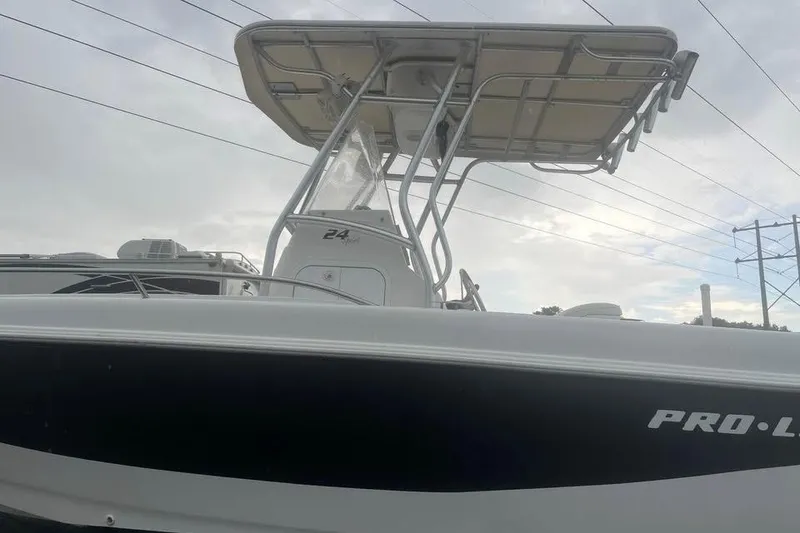 Slide: The Image of 2005 Pro-Line 24 Sport boat on trailer, parked outdoors in sunny setting. - 5