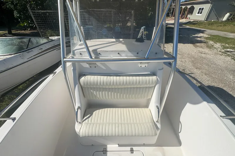 Slide: The Image of 2005 Pro-Line 24 Sport boat interior with cushioned seating and console. - 50