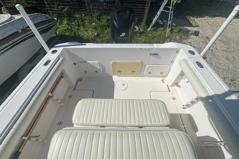 Slide: The Image of 2005 Pro-Line 24 Sport boat interior with seating and storage compartments. - 52