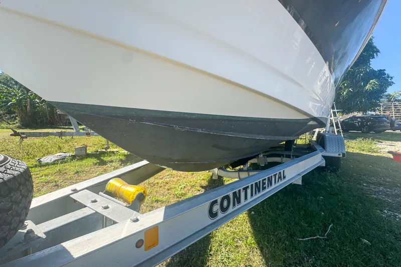 Slide: The Image of 2005 Pro-Line 24 Sport boat on Continental trailer, parked on grass. - 63