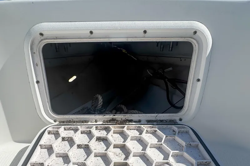 Slide: The Image of Open storage compartment on 2005 Pro-Line 24 Sport boat, showing interior details. - 64