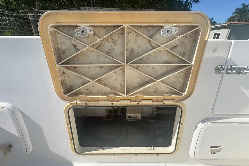 Slide: The Image of Open storage compartment on a 2005 Pro-Line 24 Sport boat. - 65