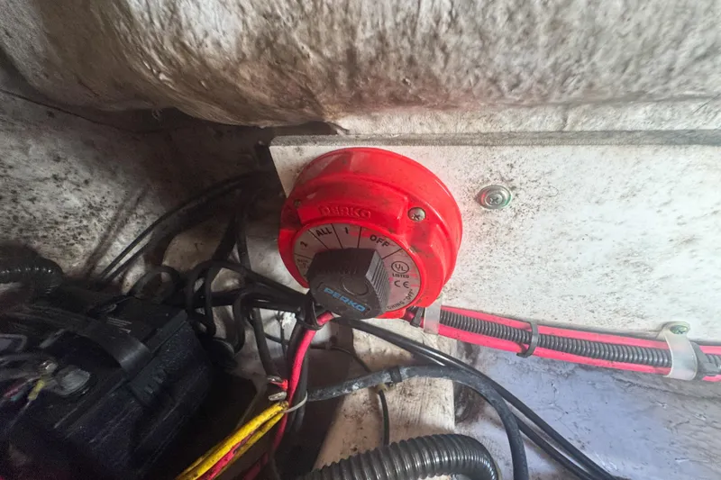 Slide: The Image of Battery switch in a 2005 Pro-Line 24 Sport boat, surrounded by wiring. - 68