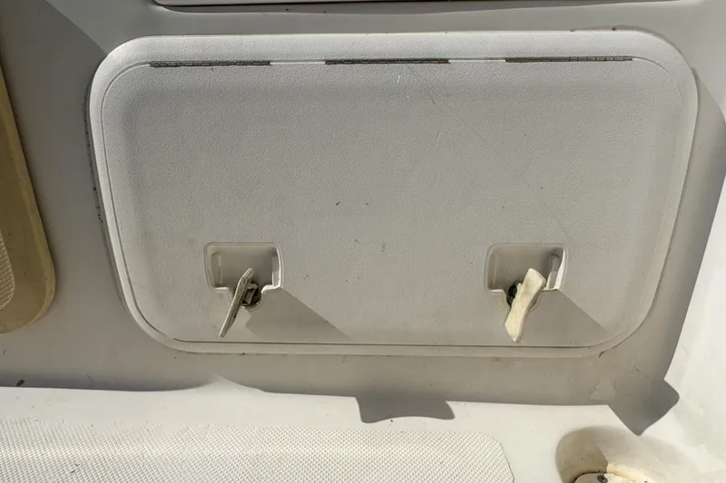 Slide: The Image of 2005 Pro-Line 24 Sport boat compartment with dual latches. - 74