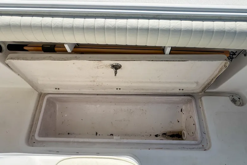 Slide: The Image of Open storage compartment on a 2005 Pro-Line 24 Sport boat, showing interior details. - 80