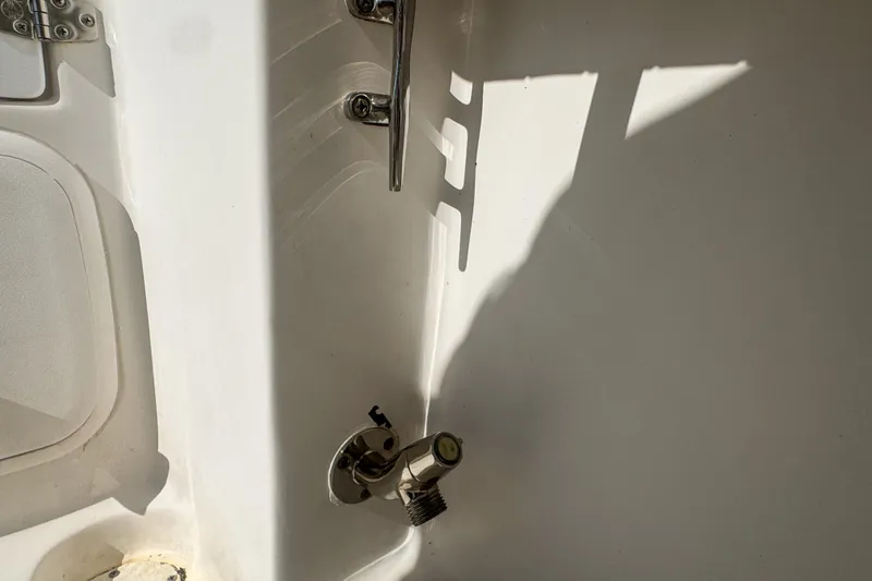 Slide: The Image of 2005 Pro-Line 24 Sport boat interior detail with metal fixtures and white surface. - 84