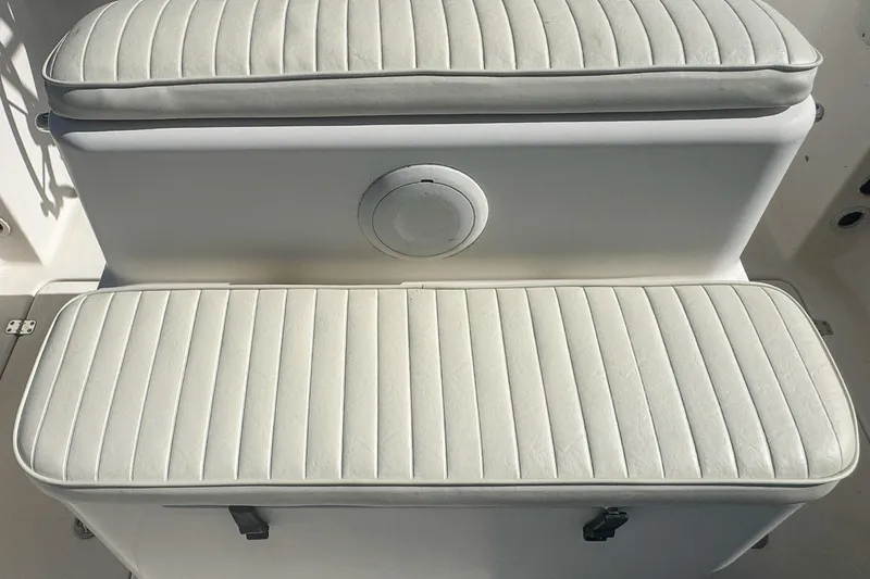 Slide: The Image of 2005 Pro-Line 24 Sport boat seating with white cushioned upholstery. - 88