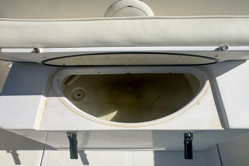 Slide: The Image of 2005 Pro-Line 24 Sport boat storage compartment with open lid. - 89