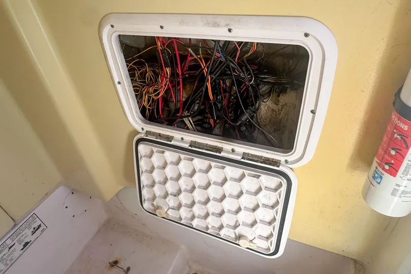 Slide: The Image of Open electrical panel on 2005 Pro-Line 24 Sport boat, showing wiring and fire extinguisher. - 95