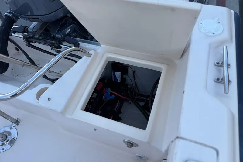 Slide: The Image of Open storage compartment on a 2008 Grady-White Sportsman 180 boat, showing internal wiring. - 18