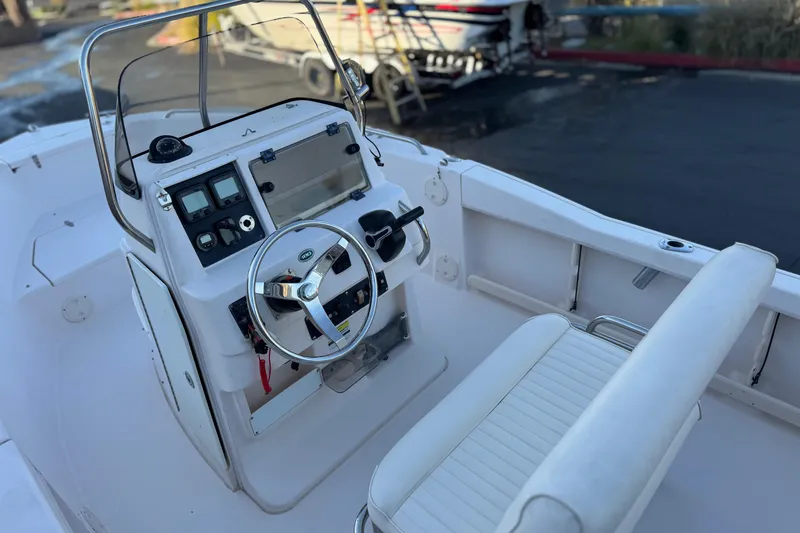 Slide: The Image of 2008 Grady-White Sportsman 180 boat interior with steering console and seating. - 19