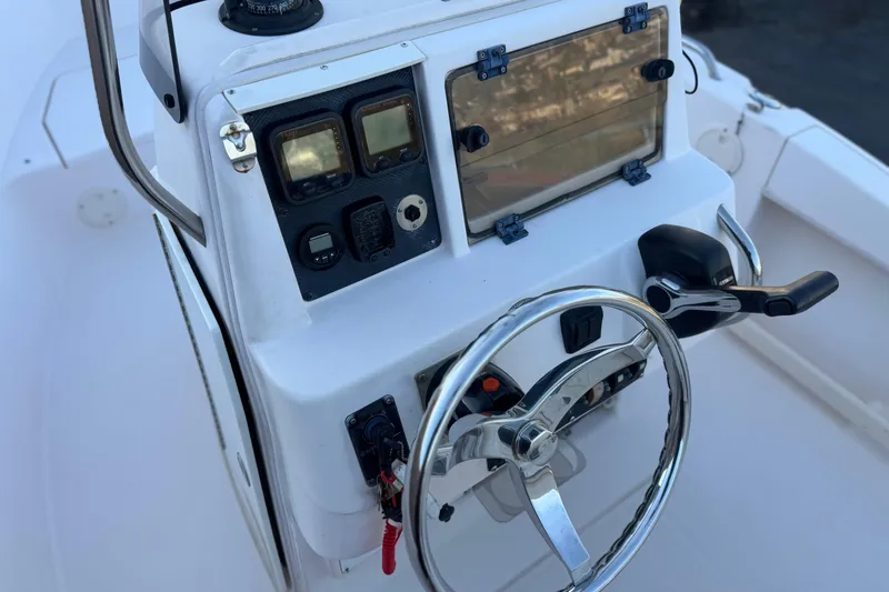 Slide: The Image of 2008 Grady-White Sportsman 180 boat console with steering wheel and controls. - 21