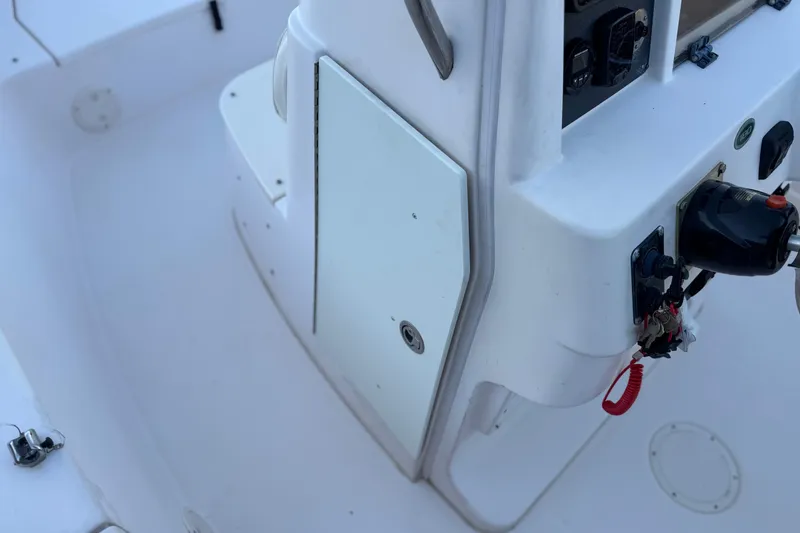 Slide: The Image of 2008 Grady-White Sportsman 180 boat interior with control panel and storage compartment. - 22