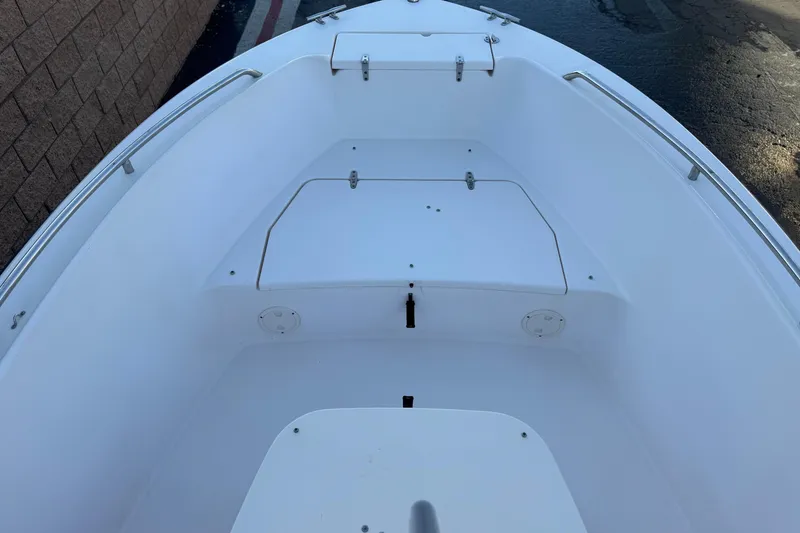 Slide: The Image of 2008 Grady-White Sportsman 180 boat interior, featuring clean white seating and storage compartments. - 9