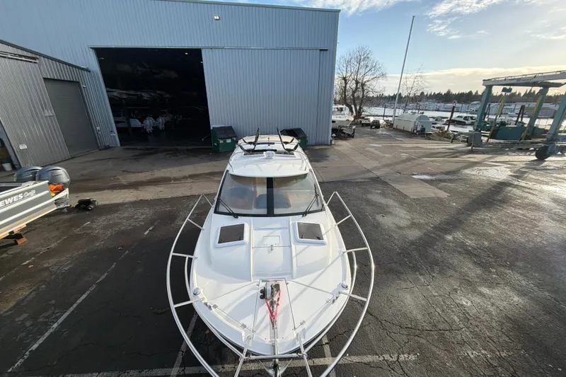 Slide: The Image of 2016 Cutwater C-242 Coupe boat parked outside a large warehouse. - 10