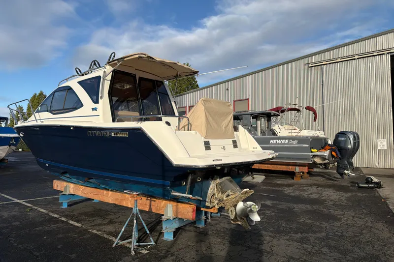 Slide: The Image of 2016 Cutwater C-242 Coupe boat on stands in a marina yard. - 13