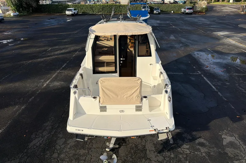 Slide: The Image of 2016 Cutwater C-242 Coupe boat parked in a lot, rear view. - 16