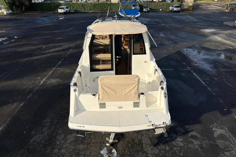 Slide: The Image of 2016 Cutwater C-242 Coupe boat, rear view in a parking lot. - 18