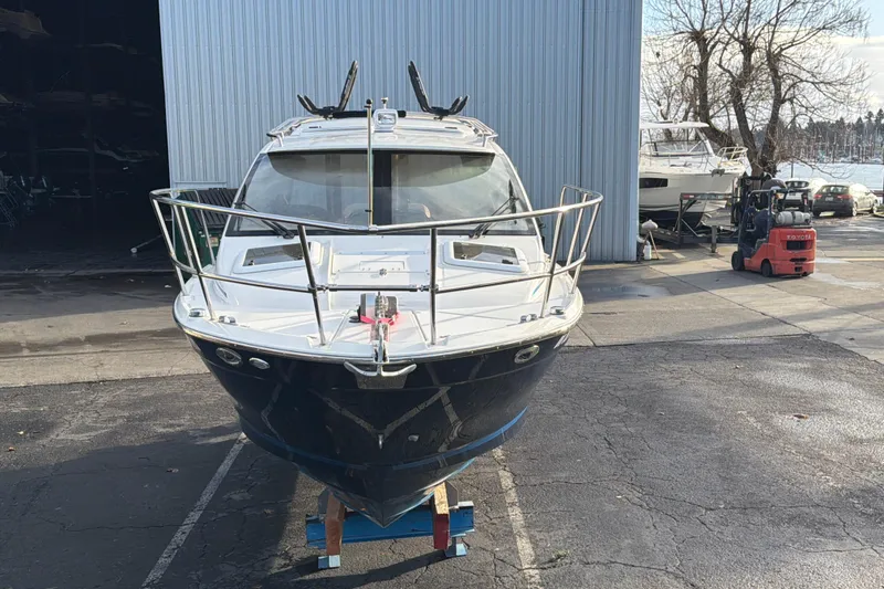 Slide: The Image of 2016 Cutwater C-242 Coupe boat in a marina, front view. - 2