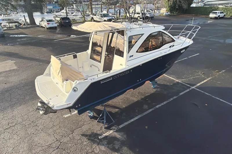 Slide: The Image of 2016 Cutwater C-242 Coupe boat on display in a parking lot. - 21