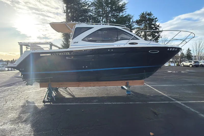Slide: The Image of 2016 Cutwater C-242 Coupe boat on stands in a parking lot, sunny day. - 22