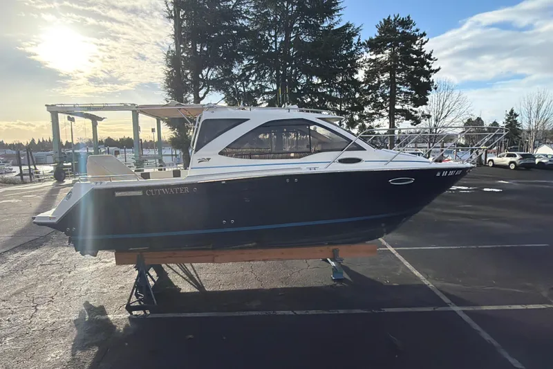 Slide: The Image of 2016 Cutwater C-242 Coupe boat on display in a parking lot, sunny day. - 23