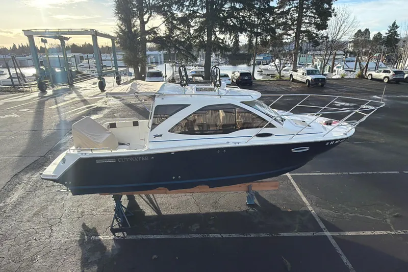 Slide: The Image of 2016 Cutwater C-242 Coupe boat on display in a marina parking lot. - 24