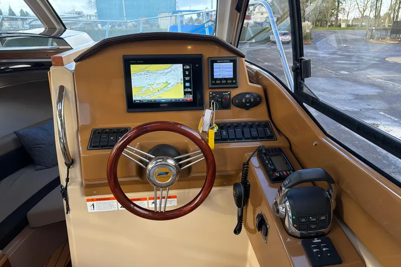 Slide: The Image of Interior helm of 2016 Cutwater C-242 Coupe with navigation display and controls. - 25