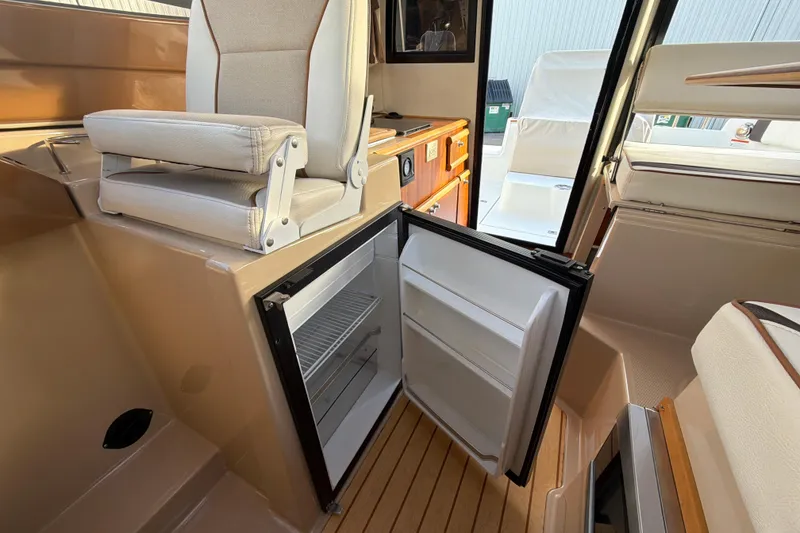 Slide: The Image of 2016 Cutwater C-242 Coupe interior with open fridge and seating. - 32