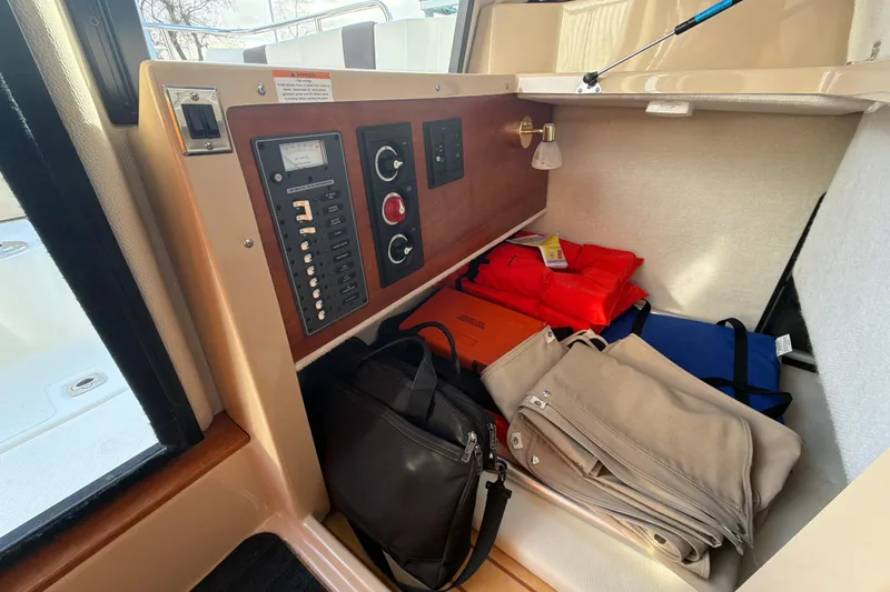 Slide: The Image of Interior of 2016 Cutwater C-242 Coupe with control panel and storage items. - 34