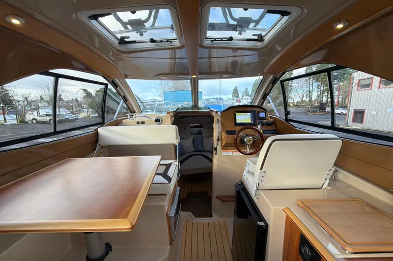 Slide: The Image of Interior of 2016 Cutwater C-242 Coupe boat with helm, seating, and table. - 36